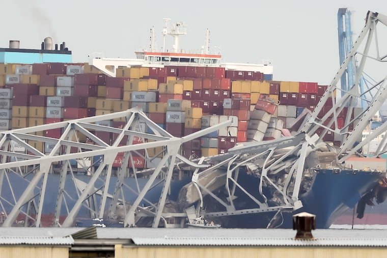 A section of the Francis Scott Key Bridge collapses after a container ship ran into it on the Patapsco River in Baltimore, Maryland on Tuesday, March 26, 2024.
