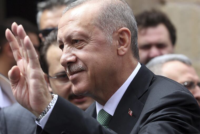 Turkey's President Recep Tayyip Erdogan listens to supporters after Friday prayers, in Bayburt, Turkey, Friday, Aug. 10, 2018.