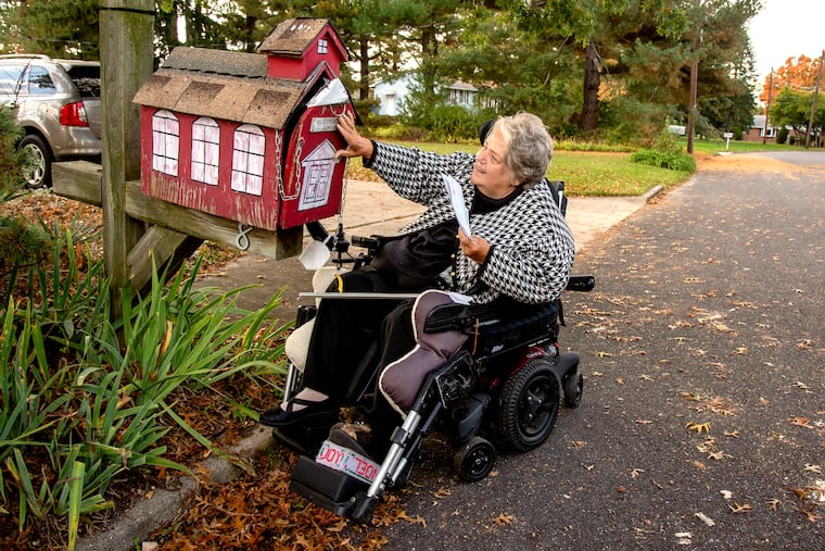 Katherine Vaczi, a retired teacher, picks up her mail — from the schoolhouse mailbox — at her home in Gloucester County. Vaczi is one of three individual plaintiffs in a lawsuit filed this month by the nonprofit Center for Medicare Advocacy seeking to force Medicare to make home-care services more easily accessible.