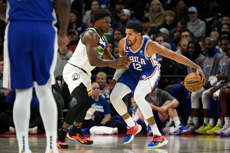 Philadelphia 76ers forward Tobias Harris (12) tries to drive past Minnesota Timberwolves guard Anthony Edwards.