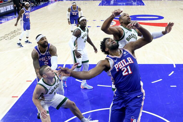 Joel Embiid and Al Horford jockey for rebounding position during the first half at the Wells Fargo Center on Nov. 15.