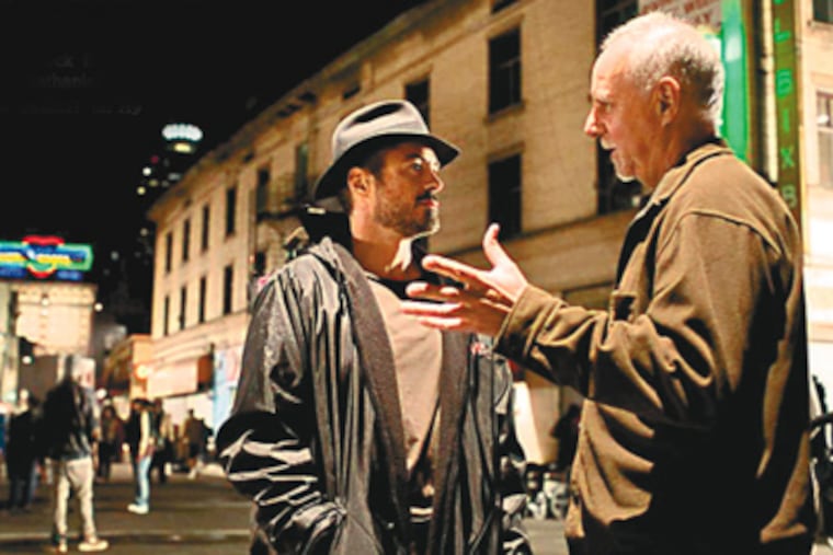 Actor Robert Downey Jr., left, who portrays columnist Steve Lopez, confers with Lopez himself during filming of 'The Soloist.' Jamie Foxx plays Nathaniel Ayers, the homeless man befriended by Lopez. (Francois Duhamel)