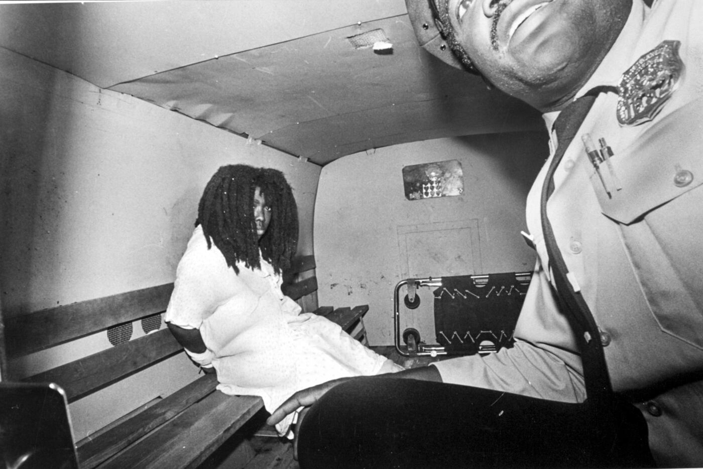 A handcuffed Ramona Africa sits in a police van after leaving Misericordia Hospital in West Philadelphia on the evening of May 13, 1985. She suffered burns after police rescued her from the burning MOVE house.