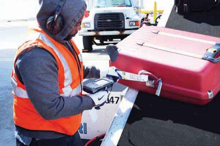 Photos of a US Airways fleet service agent scanning a bag going on, and coming off, airplanes in Philadelphia - Source: US Airways
