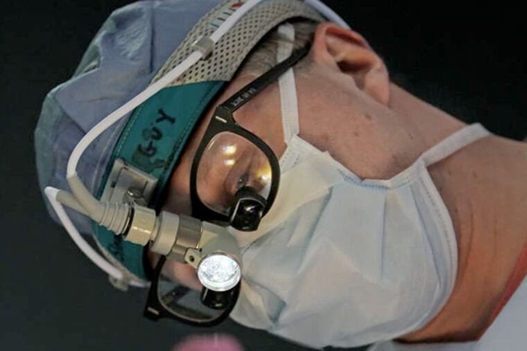 Dr. T. Sloane Guy begins placing the portals in the patient to begin theminimally invasive mitral valve heart surgery. ( MICHAEL BRYANT / Staff Photographer )