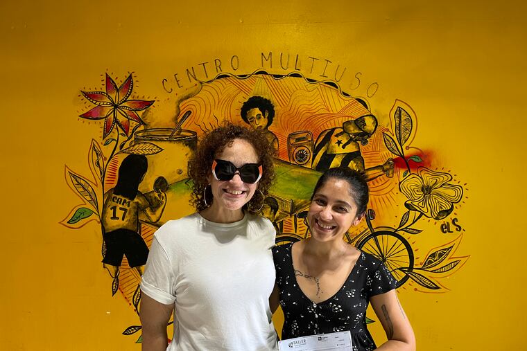 Nasheli Ortiz González, executive director of Taller Puertorriqueño gives Hurricane Fiona relief donation to Marisel Robles Gutiérrez of Comedores Sociales in Caguas, Puerto Rico