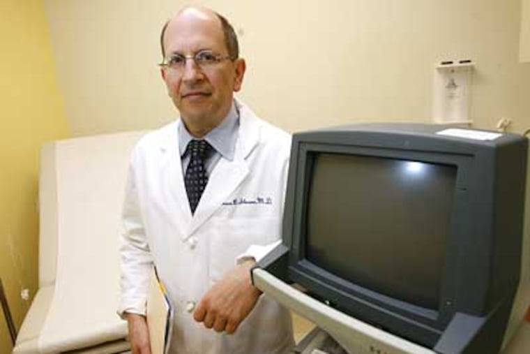 Dr. Bruce Sloane talks to his male patients before agreeing to perform vasectomies. (Charles Fox / Staff Photographer)