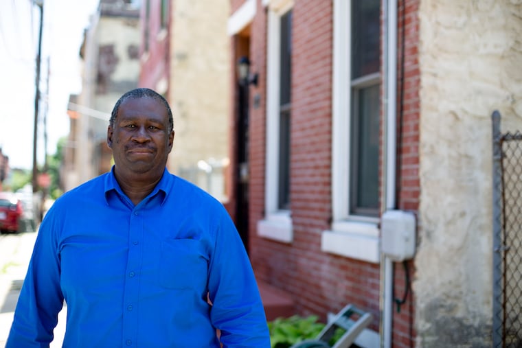 Michael Burch walks on his street in the Parkside neighborhood Tuesday, June 12, 2018. Burch grew up in the house and recently moved back after living outside the city for twenty years.
