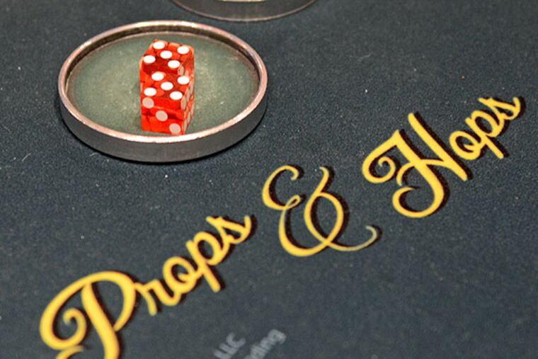 SugarHouse Casino dealer Thomas McCann and floor supervisor Mark Grochala have invented a new game, Props & Hops. ( TOM GRALISH / Staff Photographer )