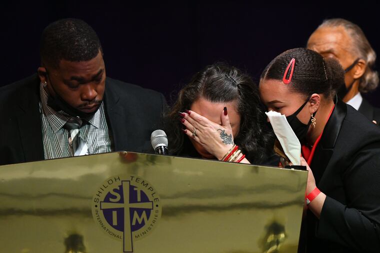 Father Aubrey Wright (left) and mother Katie Wright (center) give remarks alongside sister Diamond Wright (right) and Rev Al Sharpton during a funeral held for Daunte Wright at Shiloh Temple International Ministries in Minneapolis.