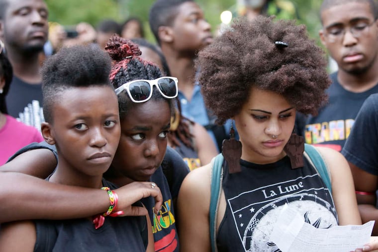 Joining hundreds in LOVE Park at a rally and moment of silence in response to the unrest in Ferguson, Mo., were (from left) Lerato Mokobe, Shakille Cordice, and Nayo Jones.
