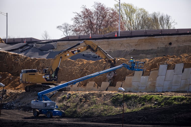 Construction workers cleaning up the collapsed retaining wall in Bellmawr in 2021. The mishap increased the length and cost of the project.