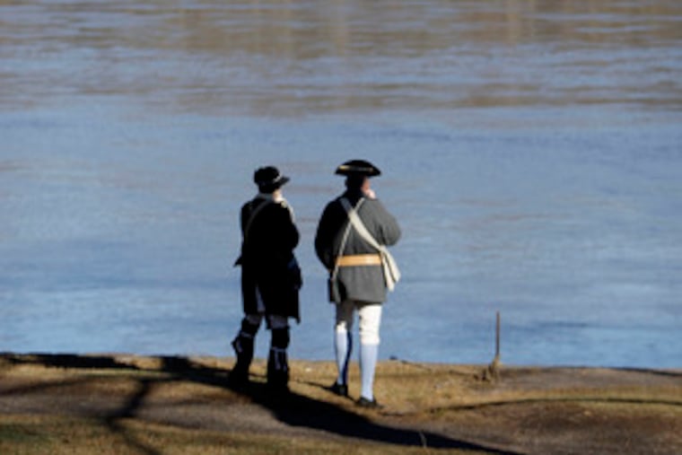 Reenactors contemplate the swift current of the Delaware. It was the second consecutive year conditions prevented a crossing.