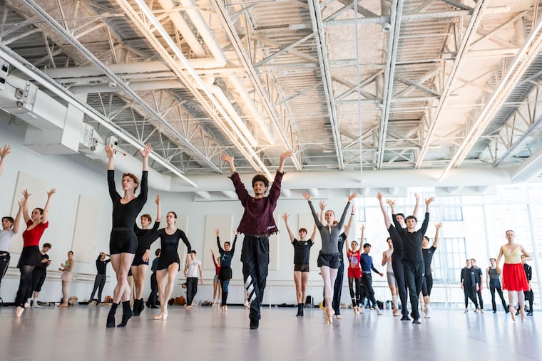 Philadelphia Ballet dancers rehearse for the first time in a sunlight-filled studio on the top floor of the company's new building on North Broad Street, April 6, 2026. Juliano Nunes (center) is seen directing choreography for the world premiere of his new "Romeo and Juliet" set to Prokofiev's score.