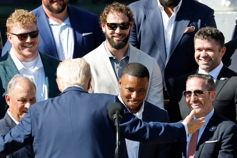 Eagles running back Saquon Barkley looks at President Donald Trump while the Eagles visited the White House on Monday.