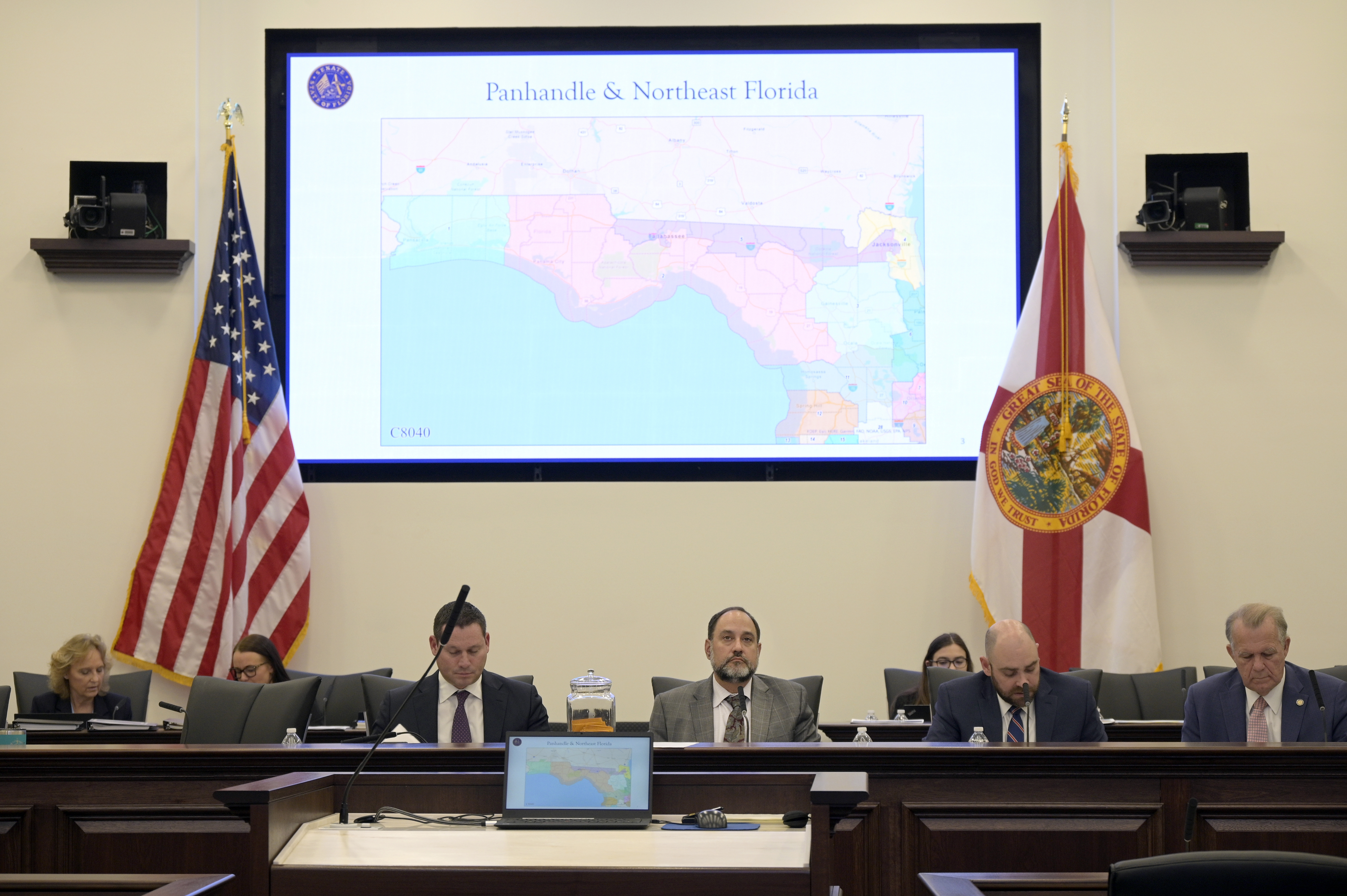 Florida Sen. Ray Rodrigues (center) views redistricting maps on a video monitor as an identical one is displayed behind him during a Senate Committee on Reapportionment hearing in a legislative session in Tallahassee, Fla.