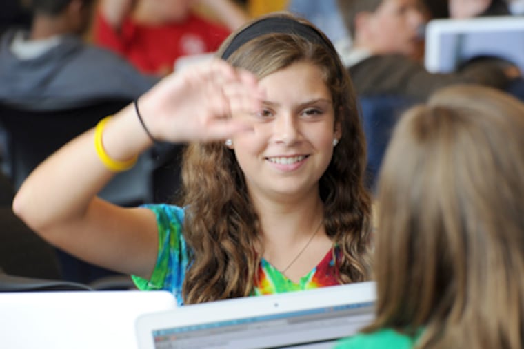 At Downingtown STEM Academy, Halle Smith, 14, raises her hand to answer a question in a data accessing information class. (Sharon Gekoski-Kimmel / Staff Photographer)