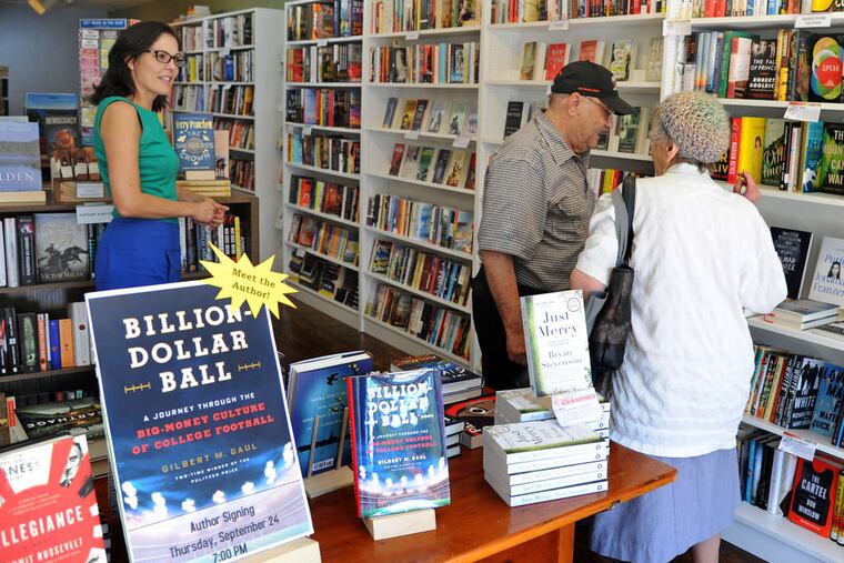 Julie Beddingfield (left), the owner of Inkwood Books on Kings Highway in Haddonfield, talks with customers in 2015. Her store moved to larger quarters across the street last year, amid a particularly challenging period for booksellers.