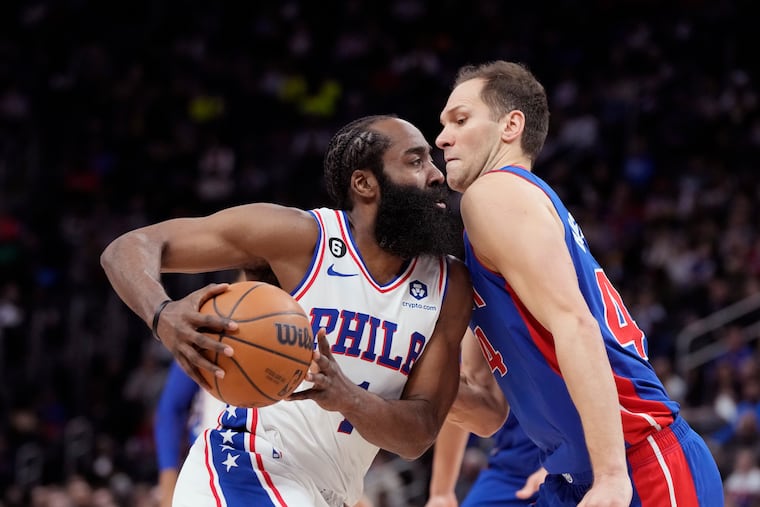 Pistons forward Bojan Bogdanovic fouls 76ers guard James Harden during the first half.
