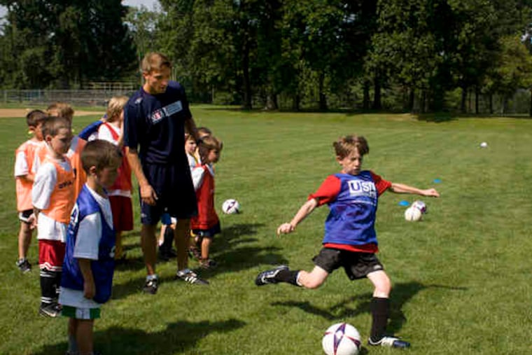 Huckett watches Kyle Schoener, 10, of Jenkintown, boot the ball. "Back in England, all they want to do is play in games," Huckett says. "Here, they want to practice more."