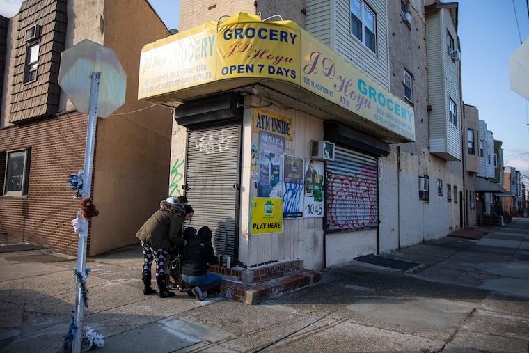Debbie Leonardi, 53, Ashley Leonardi, 34, niece, Melissa Capozzoli, 28, daughter to Debbie, and Capozzoli's son, Alejandro Torres, 3, came to visit and pay their respects to the family by leaving candles at the J.D. Hoyu Grocery in South Philadelphia at the corner of 9th Street and Porter Street on Wednesday, Jan. 8, 2020. The family are neighborhood friends and live right down the road from the corner store. "They're a nice quiet family," Debbie said. "As soon as I heard I got upset. I hope they catch him."