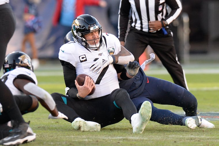 Jaguars quarterback Nick Foles (7) is sacked by Titans linebacker Harold Landry for an 8-yard loss on Sunday.