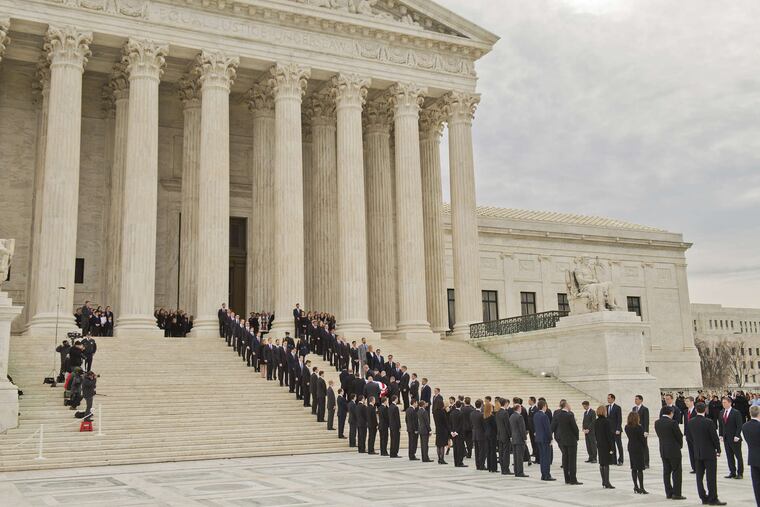 The justice's casket is carried into the Supreme Court. His former law clerks served as honorary pallbearers.
