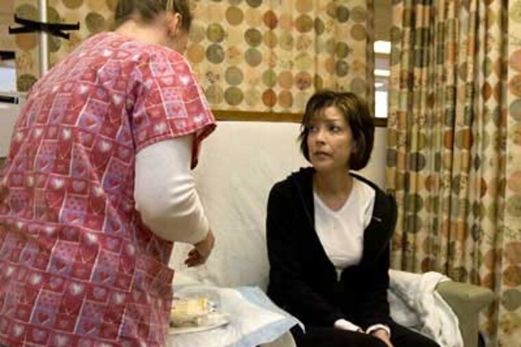 Susan Gildin, a colon cancer patient, prepares for chemotherapy at Jefferson Infusion Center of Thomas Jefferson University Hospital. Husband Brad has never gotten used to the emotional turmoil tests bring. (Ed Hille / Staff Photographer)