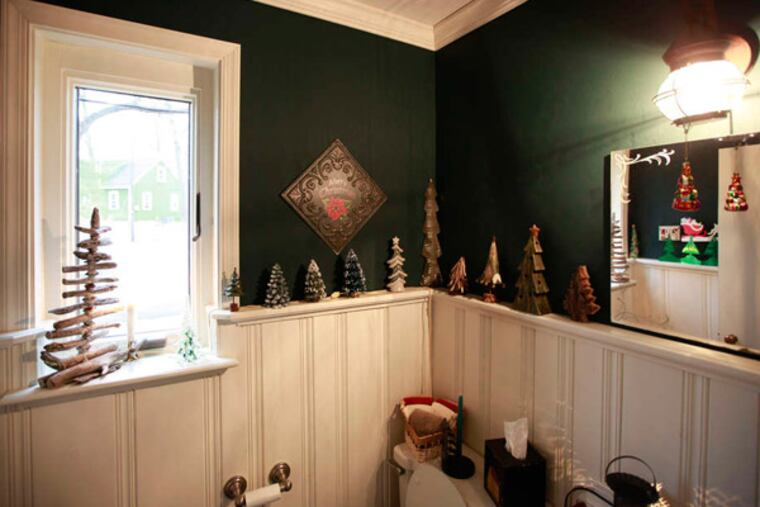 Yuletide trees of all shapes and sizes line the chair rail of the Barrs' home. Every item in the couple's vast Christmas collection prompts a memory - figurines from friends and relatives, tokens from trips, mementos from their childhoods.