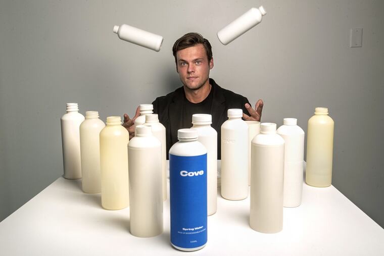 Alex Totterman, CEO and founder of Cove Water in Culver City, Calif., is photographed on Oct. 2, 2020 with a mix of prototype and actual plastic water bottles, as well as bottle caps and label that he says are made up entirely of biodegradable material. The company will begin selling the bottled water sometime in the fall. (Mel Melcon/Los Angeles Times/TNS)