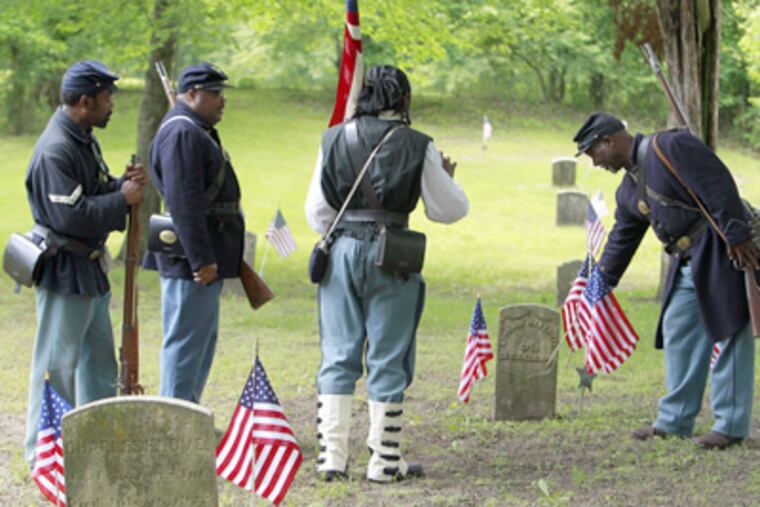 Reenactors of the Sixth Regiment United States Colored Troops pay tribute to African American Civil War veterans buried in the cemetery of the tiny village of Timbuctoo in Westampton Twp., Burlington County. (Akira Suwa / Staff Photographer)