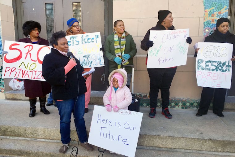 Parents rally at Cooke Elementary in Logan, one of two schools awaiting a School Reform Commission vote Thursday on whether to be turned over to a charter.