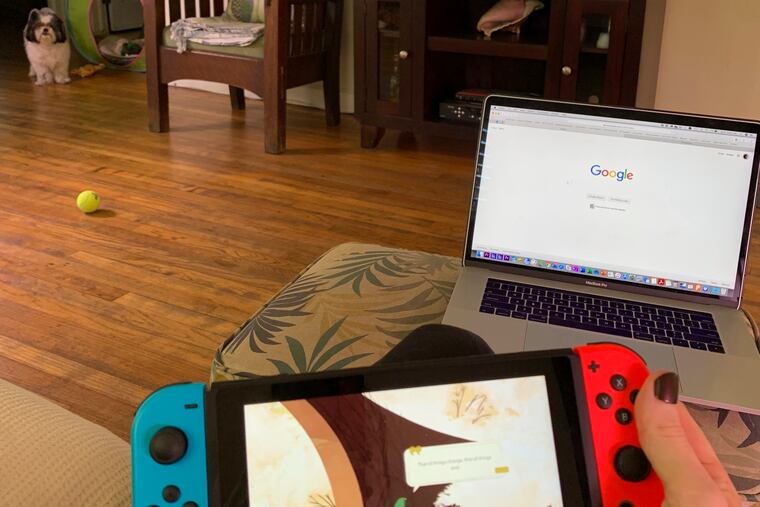 Associated Press writer Tamara Lush plays video games during the coronavirus outbreak with the news on the television in the background Oct. 26, 2020, in St. Petersburg, Fla. (AP Photo/Tamara Lush)