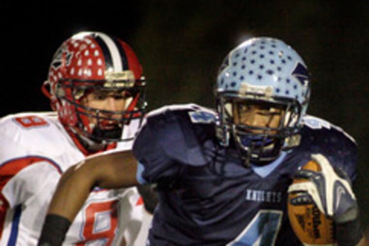 North Penn's Ronnie Akins checks the road behind him as he sprints toward the end zone for North Penn's first touchdown. Neshaminy's Matt Knorr gives chase.