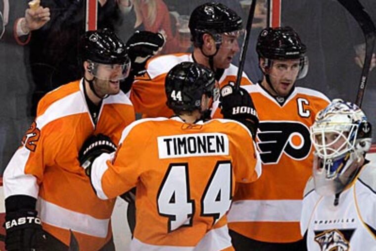 Flyers forward Ville Leino (far left) celebrates his first of two third period goals with his teammates. (Yong Kim/Staff Photographer)