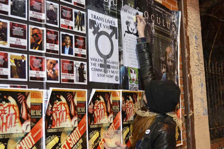 Riot's still going on: An activist posts a flier for transgender rights.
