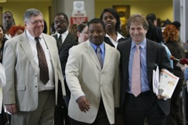Jerry Miller is flanked by Rob Warden (left), of Northwestern University's Center on Wrongful Convictions, and Barry Scheck, of the Innocence Project, after being cleared yesterday.