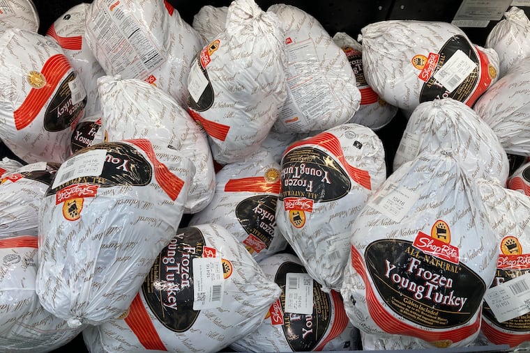 Frozen turkeys are displayed at a supermarket in Philadelphia last year. Americans are bracing for a costly Thanksgiving this year, with double-digit percent increases in the price of turkey, potatoes, stuffing, canned pumpkin, and other staples.