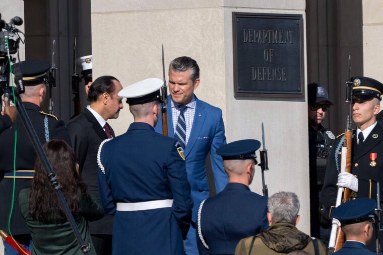 Defense Secretary Pete Hegseth, center, welcomes Qatar Minister of Defense Sheikh Saoud Al Thani to the Pentagon on Friday in Washington.