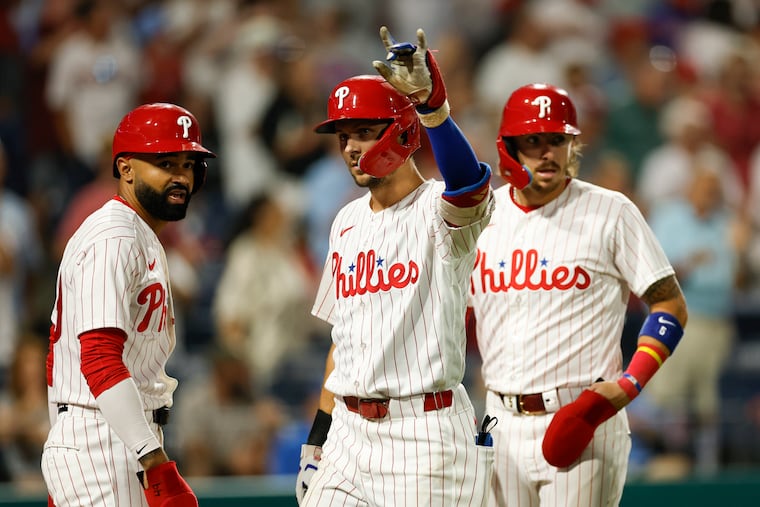 Trea Turner celebrates his sixth inning three-run home run with Derek Hill and Bryson Stott against the Dodgers on Monday.