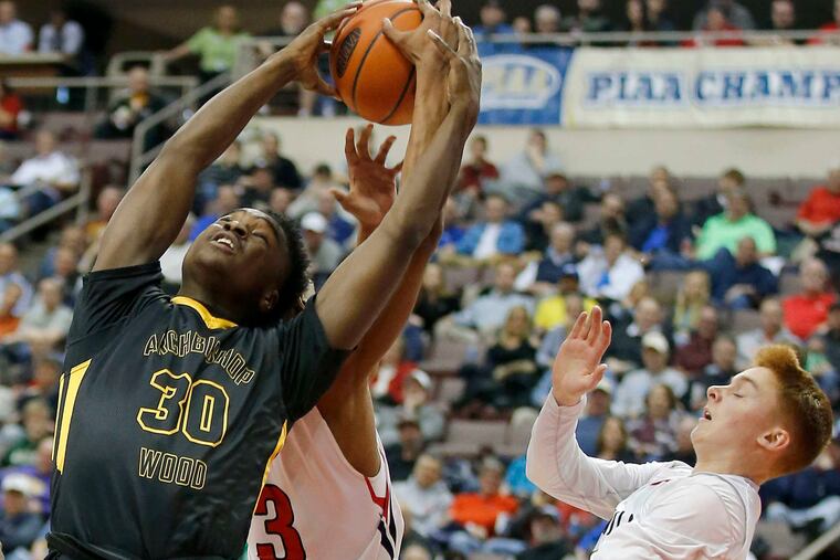Archbishop Wood High's Julius Phillips grabs a rebound against Meadville High's Armoni Foster and Jack Stevens earlier this season.