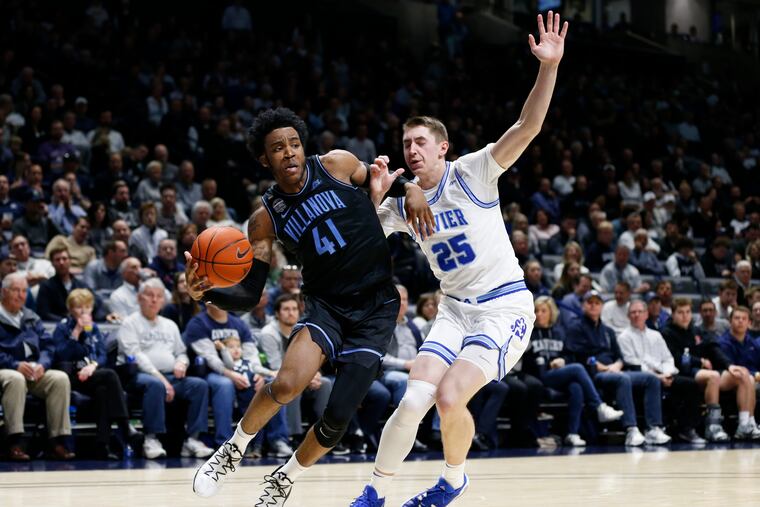 Villanova forward Saddiq Bey (41) battles Xavier forward Jason Carter (25) as he drives to the basket during the second half of an NCAA college basketball game, Saturday, Feb. 22, 2020, in Cincinnati. Villanova won 64-55. (AP Photo/Gary Landers)