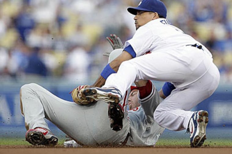 Jayson Werth slides hard into the Dodgers' Rafael Furcal during last year's NLCS. (Ron Cortes / Staff Photographer)
