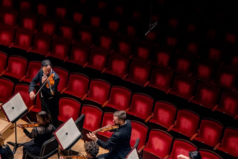 The seats in Verizon Hall are empty Mar. 12, 2020 as Philadelphia Orchestra concert master David Kim tunes the orchestra at their concert at the Kimmel Center Mar. 12, 2020. The Orchestra cancelled all rehearsals, performances, and events through March 23 to limit community transmission of the coronavirus. The program, which included Beethoven’s Symphonies No. 5 and 6, was shown in a live webcast.