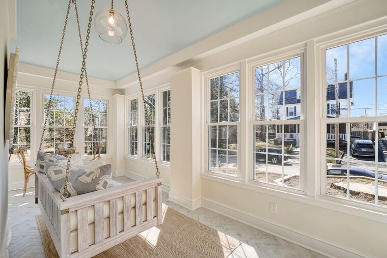 The sitting room, complete with swing, has lots of light and great street views.