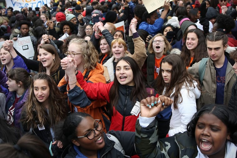 Students chant during a national student walkout in support of gun control at City Hall on Wednesday, March 14, 2018.