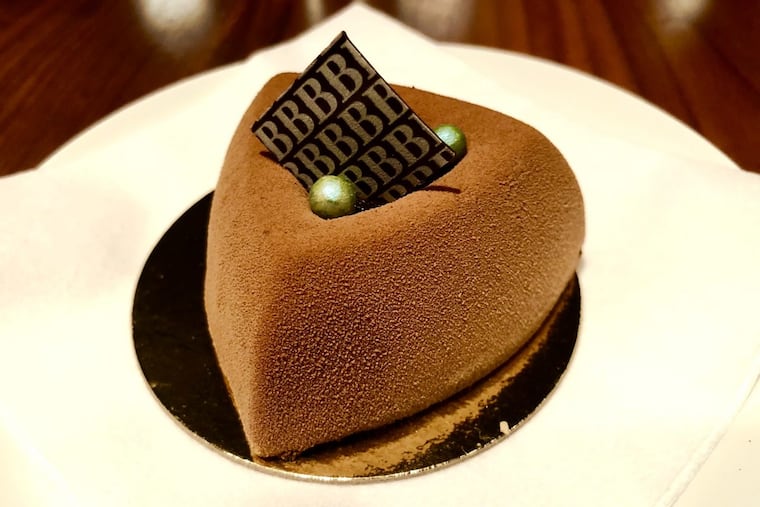 The Thai basil flourless chocolate cake from Bistro Barberet in Lancaster is sprayed with a velvety chocolate texture and stuffed with dark chocolate mousse and a heart of Thai basil and tart cranberries.
