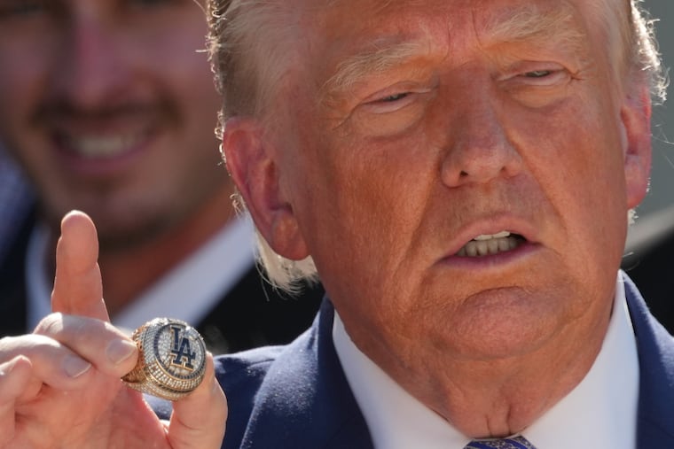 President Donald Trump holds a championship ring during an event to honor the 2025 World Series champions Los Angeles Dodgers in the Rose Garden of the White House, Thursday, July 23, 2026, in Washington. (AP Photo/Alex Brandon)