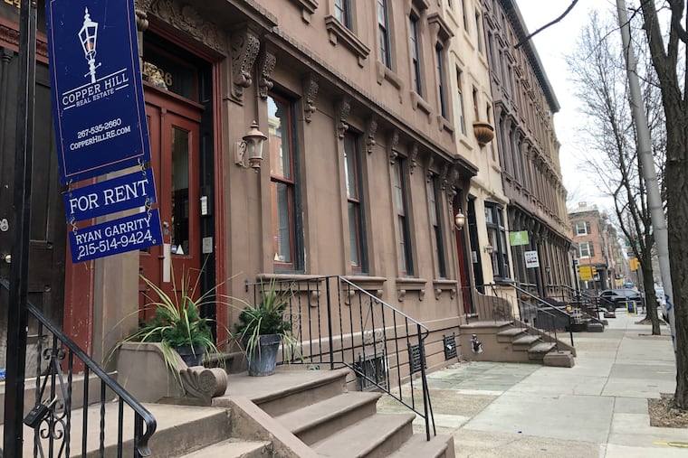 Signs advertising rental units lined a block on Pine Street in Center City this winter.