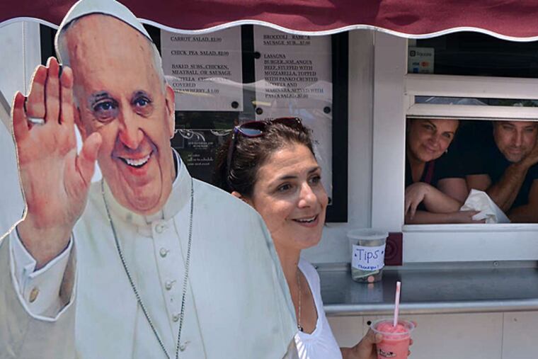 "Happy Catholic" Christa Scalies takes her Pop-Up Pope cardboard cutout around the farmers market in Wilmington, Del.